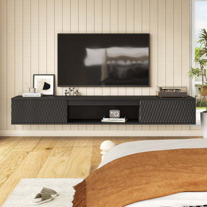 Black floating TV console mounted below a television in a bedroom