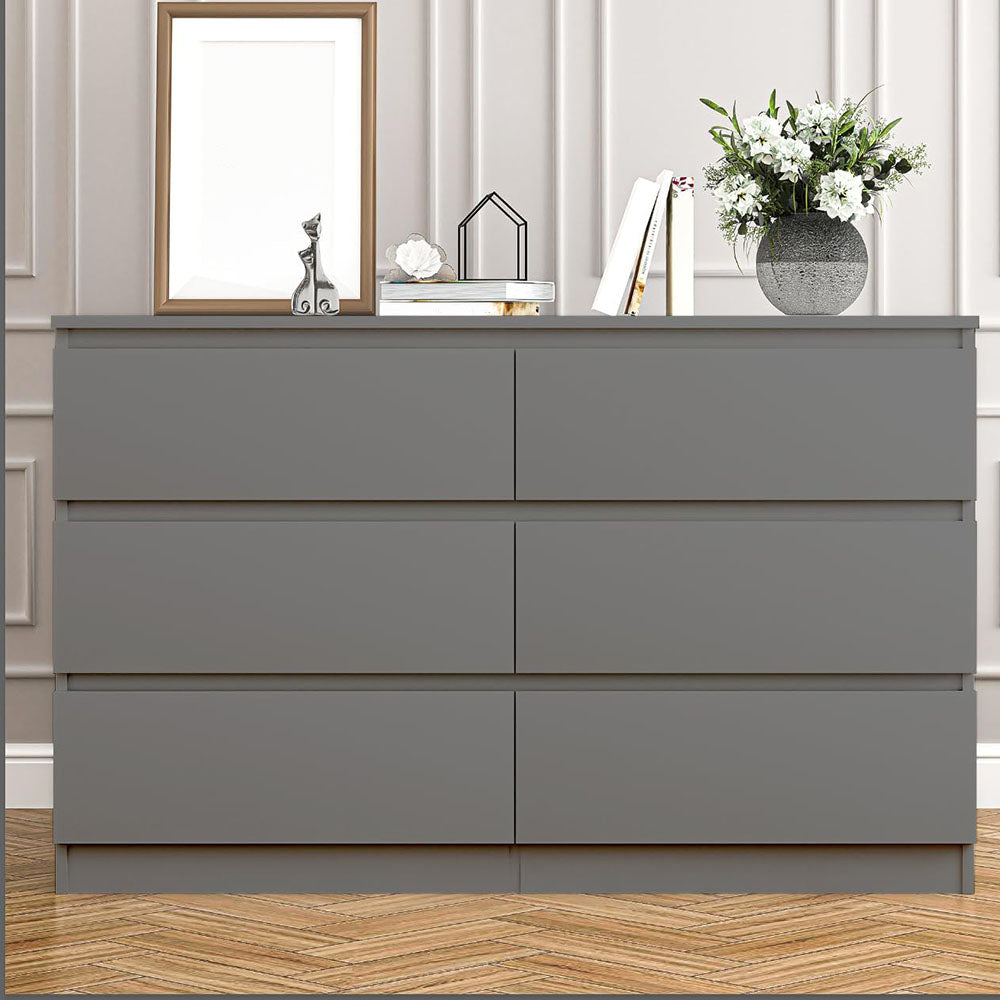 Front view of gray handleless dresser in a furnished room