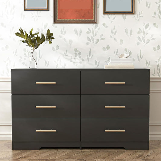 Black six-drawer dresser with gold-tone handles in a bedroom