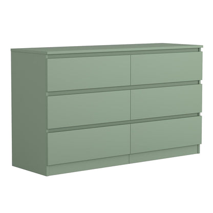 Angled view of green handleless six-drawer dresser