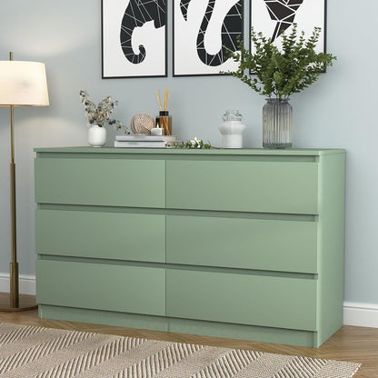 Green double dresser styled with a mirror and room accessories
