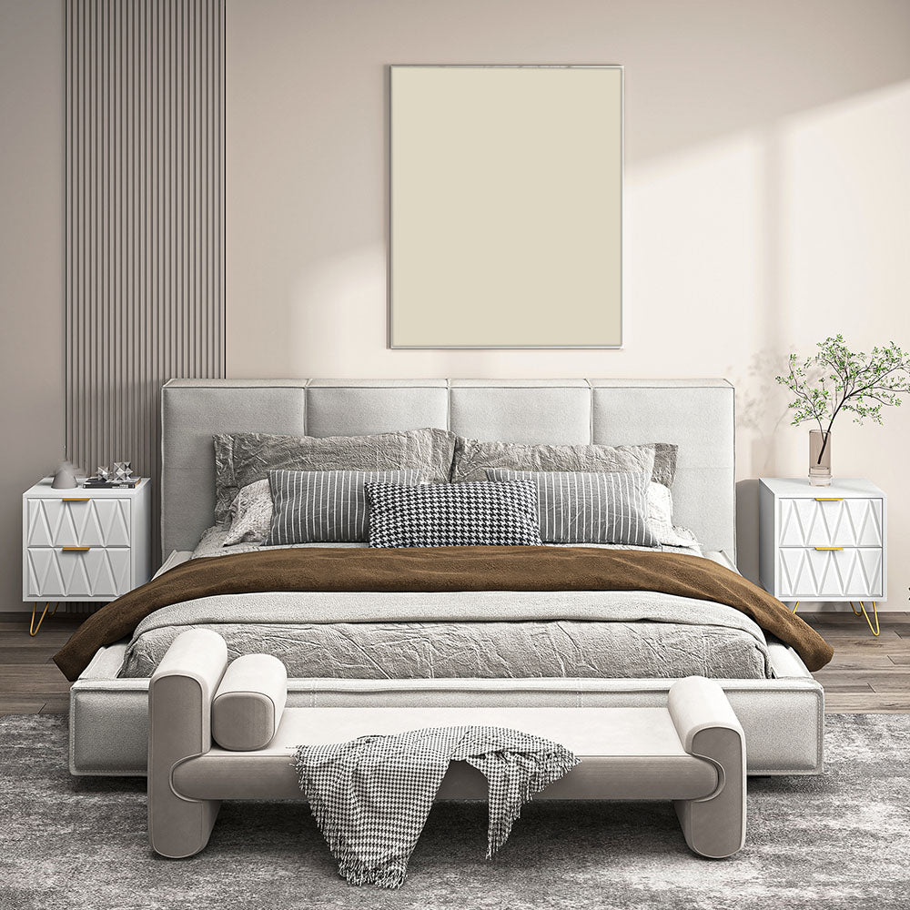 Two white chevron nightstands placed beside a bed